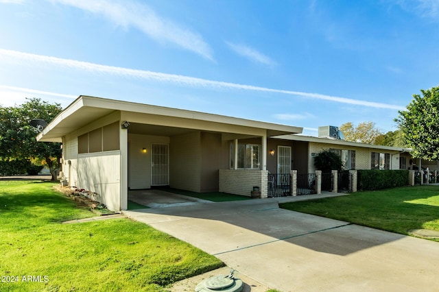 single story home with a front yard, a carport, and cooling unit