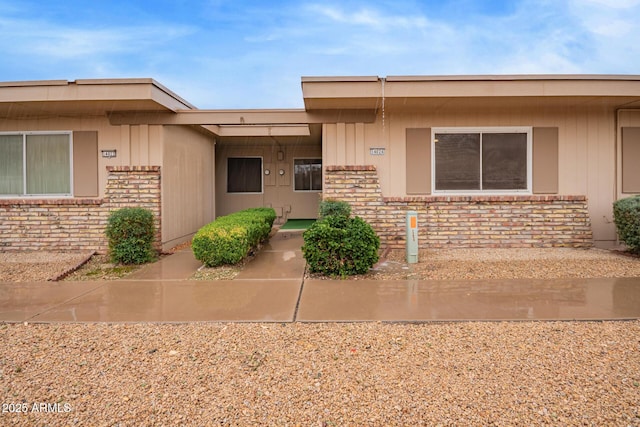 doorway to property featuring brick siding