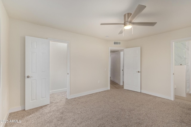 unfurnished bedroom featuring carpet, visible vents, and baseboards