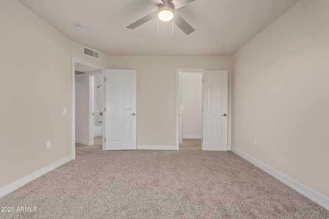 unfurnished bedroom featuring a ceiling fan, visible vents, light carpet, and baseboards