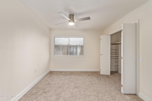 unfurnished bedroom with ceiling fan, carpet floors, and baseboards