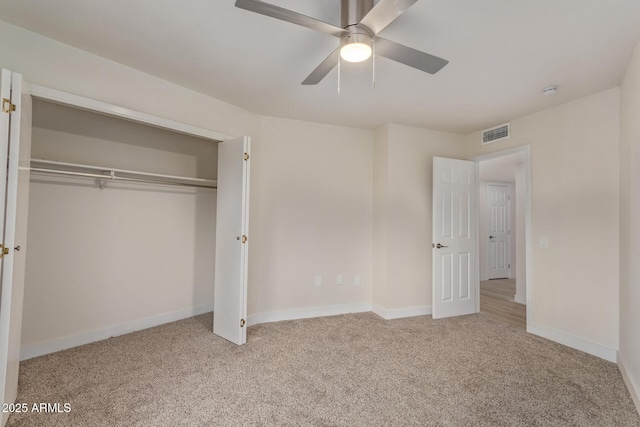 unfurnished bedroom with carpet, a closet, visible vents, a ceiling fan, and baseboards