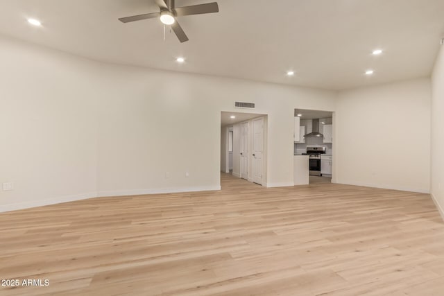 unfurnished room featuring light wood finished floors and recessed lighting