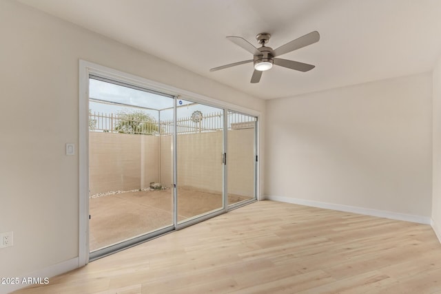 unfurnished room featuring light wood-type flooring, baseboards, and a ceiling fan