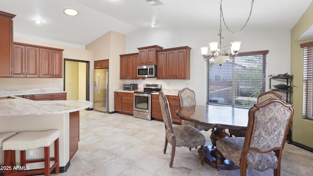 833 N 110th St, Mesa, AZ 85207 - kitchen with stainless steel appliances, a chandelier, lofted ceiling, decorative light fixtures, and light stone countertops