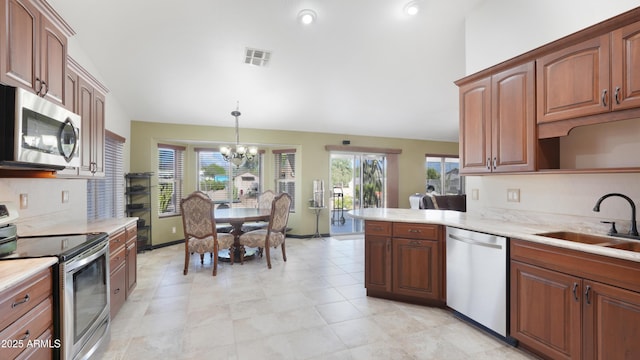 833 N 110th St, Mesa, AZ 85207 - kitchen featuring appliances with stainless steel finishes, a sink, a chandelier, and light countertops