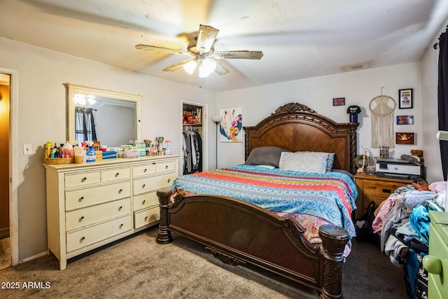 carpeted bedroom with a ceiling fan, a walk in closet, and a closet