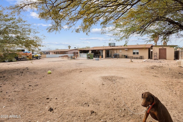 rear view of property featuring stucco siding