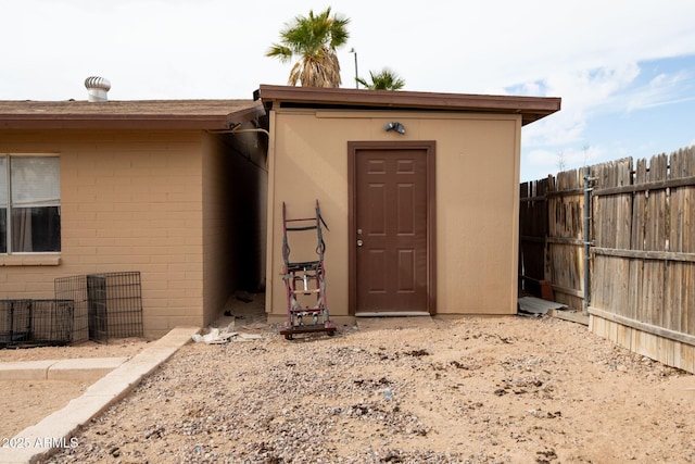 entrance to property featuring fence