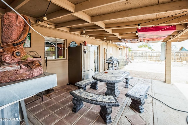 view of patio / terrace featuring a grill and fence