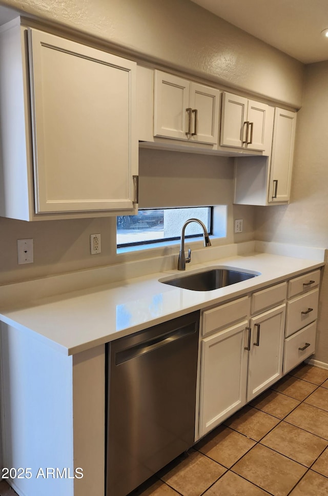 kitchen featuring dishwasher, white cabinetry, sink, and light tile patterned floors