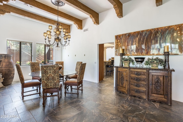 dining space with visible vents, a towering ceiling, an inviting chandelier, stone tile flooring, and beam ceiling