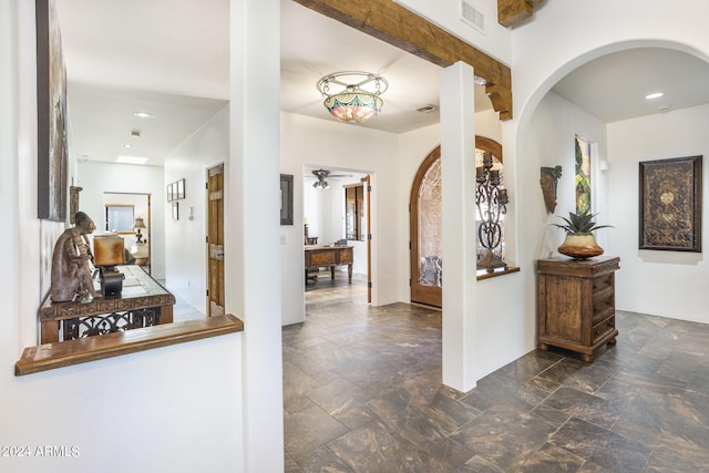 corridor with stone finish flooring, visible vents, and recessed lighting