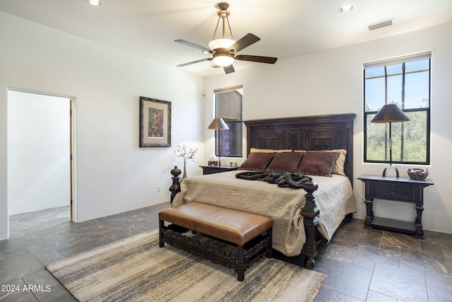 bedroom featuring stone tile floors, visible vents, ceiling fan, and recessed lighting