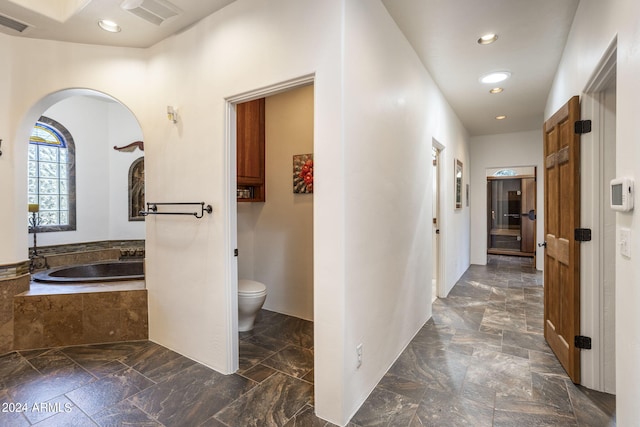 hall featuring visible vents and recessed lighting