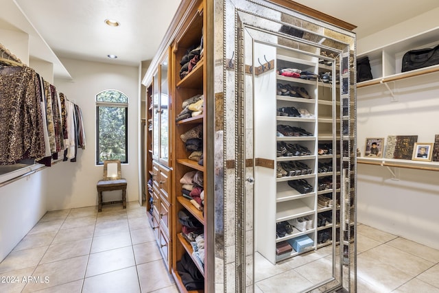 walk in closet with tile patterned flooring