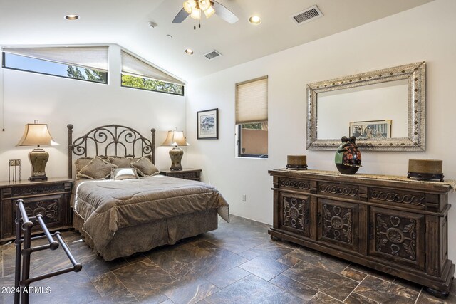 bedroom featuring lofted ceiling, multiple windows, and visible vents