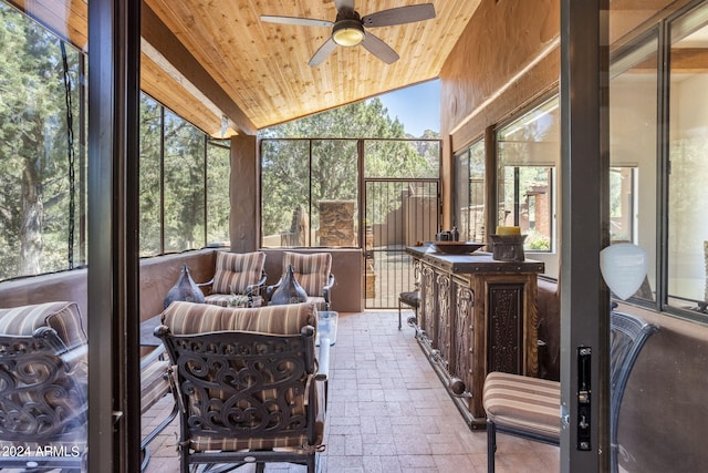 sunroom / solarium featuring lofted ceiling, wood ceiling, and ceiling fan