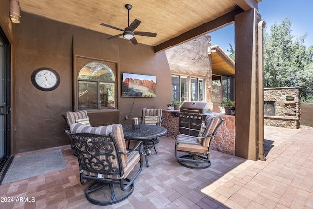 view of patio featuring an outdoor living space with a fireplace, a grill, and a ceiling fan