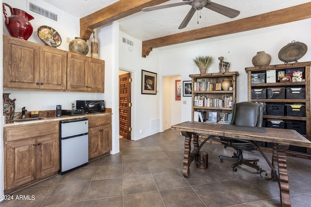 home office featuring a sink, dark tile patterned floors, visible vents, and beam ceiling