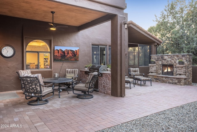 view of patio featuring ceiling fan, an outdoor living space with a fireplace, and a grill