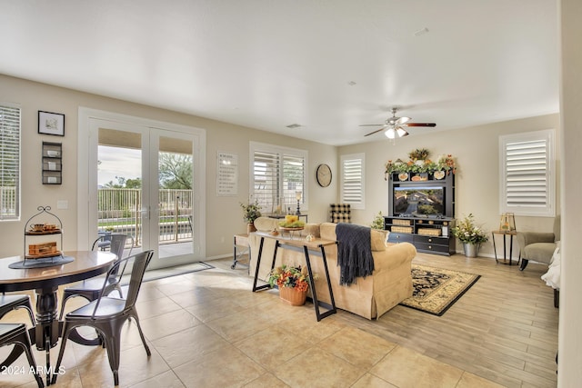 tiled living room with french doors and ceiling fan