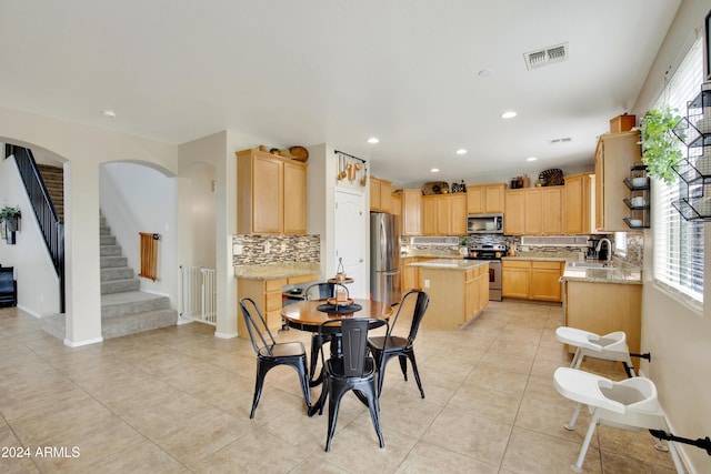 tiled dining space featuring sink