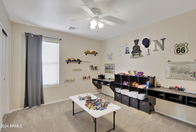 game room featuring ceiling fan and light carpet