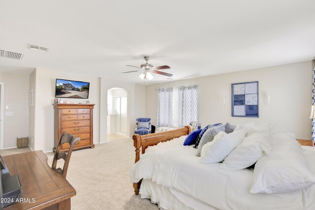 bedroom featuring light carpet and ceiling fan