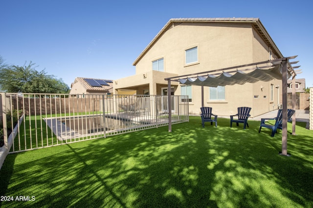 back of property with a pergola, a yard, and a patio area