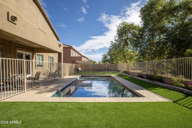 view of swimming pool with a yard and a patio