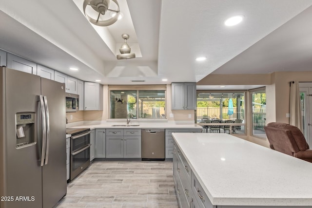 15849 N 46th Pl, Phoenix, AZ 85032 - kitchen featuring stainless steel appliances, gray cabinetry, a sink, light countertops, and recessed lighting