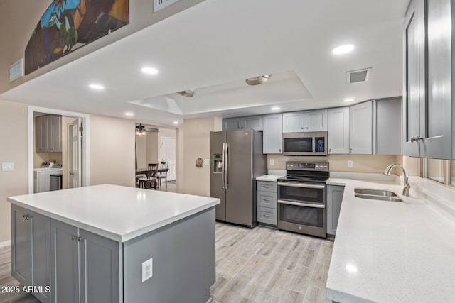 15849 N 46th Pl, Phoenix, AZ 85032 - kitchen with stainless steel appliances, gray cabinets, washing machine and dryer, a sink, and recessed lighting