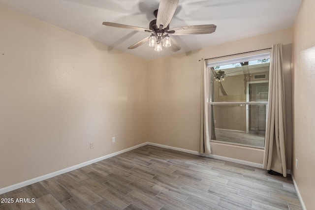 15849 N 46th Pl, Phoenix, AZ 85032 - empty room with wood finished floors, a ceiling fan, and baseboards