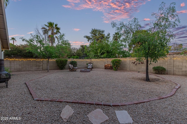 15849 N 46th Pl, Phoenix, AZ 85032 - yard at dusk featuring an outdoor fire pit and a fenced backyard