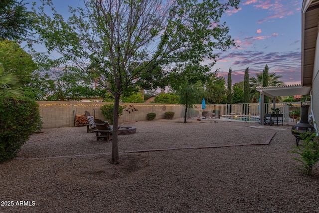 15849 N 46th Pl, Phoenix, AZ 85032 - yard at dusk featuring a fenced backyard and a patio