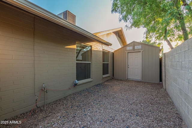 15849 N 46th Pl, Phoenix, AZ 85032 - view of home's exterior featuring a storage unit, fence, and an outbuilding
