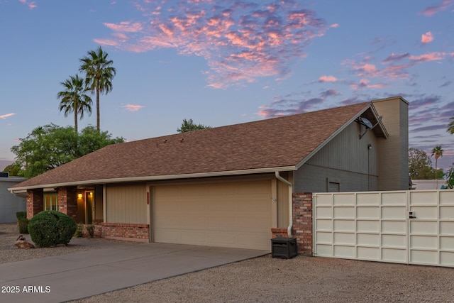 15849 N 46th Pl, Phoenix, AZ 85032 - view of front of house with brick siding, a garage, concrete driveway, a chimney, and a shingled roof