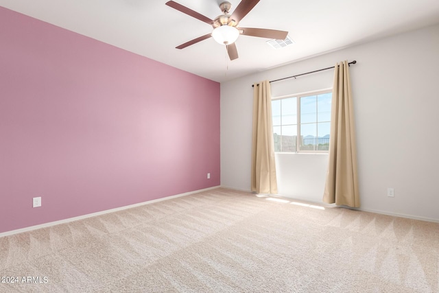 spare room with carpet flooring and ceiling fan