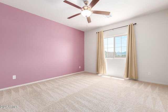 spare room featuring carpet floors and ceiling fan