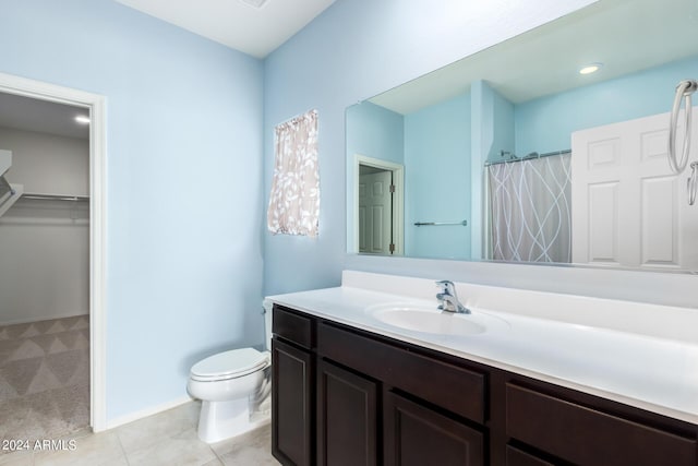 bathroom with tile patterned floors, vanity, and toilet