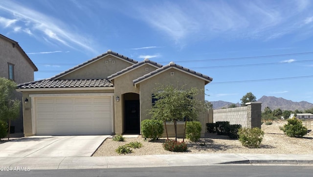 view of front of house featuring a garage and a mountain view