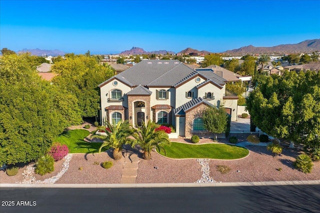 view of front facade with a mountain view and a front lawn