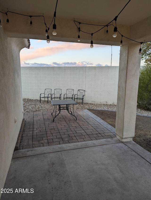 view of patio with outdoor dining space and fence