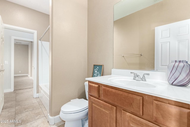 bathroom featuring bathing tub / shower combination, toilet, vanity, baseboards, and tile patterned floors