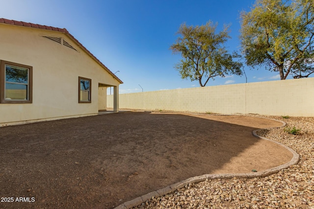 view of yard featuring a patio and a fenced backyard