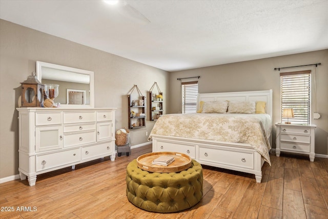 bedroom featuring multiple windows and light hardwood / wood-style floors