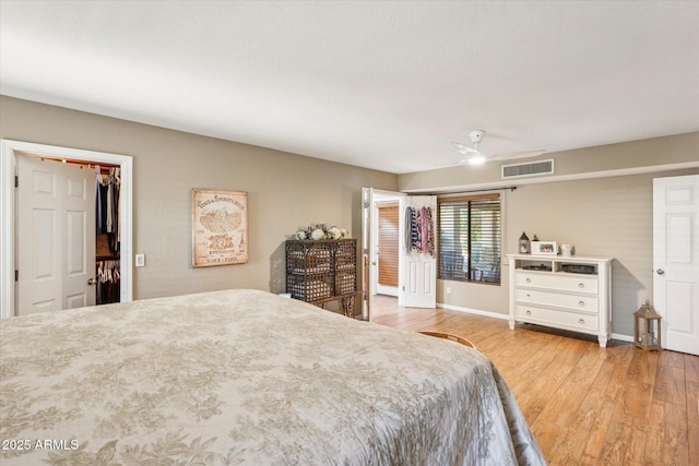 bedroom featuring ceiling fan, light hardwood / wood-style floors, and a closet