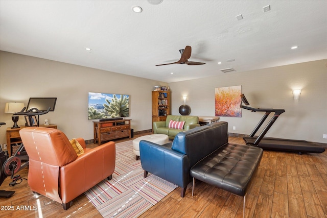 living room with ceiling fan and light wood-type flooring