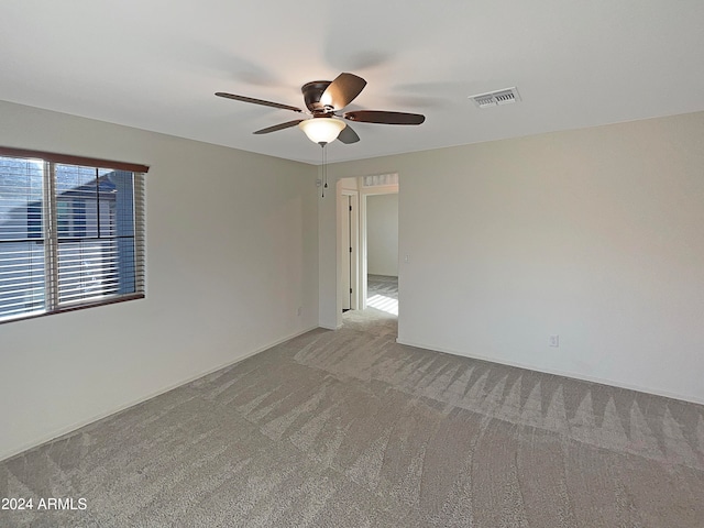 unfurnished room with light carpet and ceiling fan